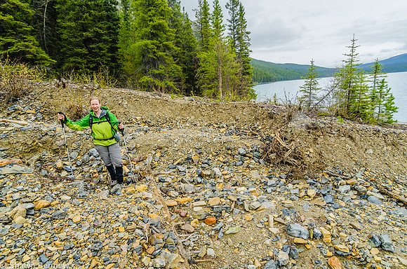 Jenn hiking across a dry creek bed on the north shore of Glacier Lake.