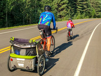 James and Shawn biking past Jenn.