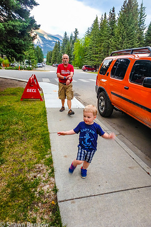 Uncle Bruce and James walking along the sideway in Canmore.