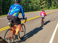 James and Shawn biking past Jenn.
