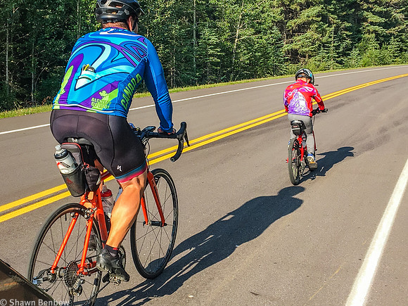 James and Shawn biking past Jenn.