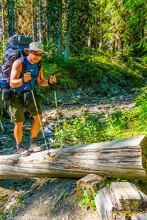 Shawn crossing a small tributary to Tumbling Creek.
