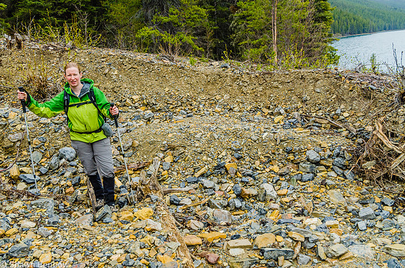 Jenn hiking across a dry creek bed on the north shore of Glacier Lake.