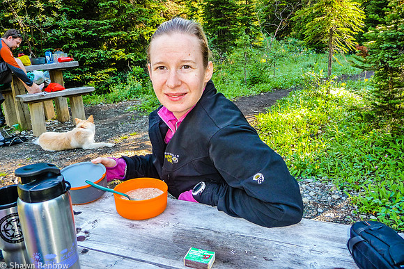 Jenn eating her oatmeal and tea for breakfast at Helmet Falls Campground.