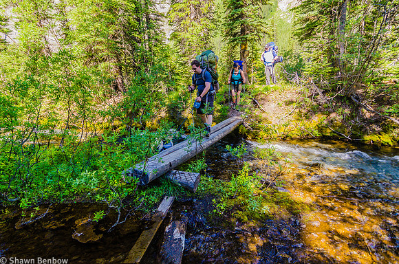 Adam, Christina, and Mark crossing a small stream on the Rockwall Trail.