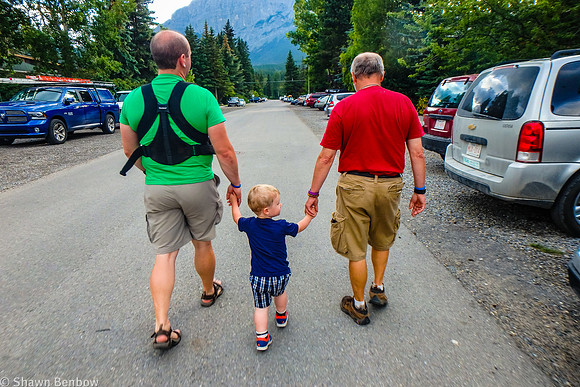 Shawn (carrying Walter), James, and Uncle Bruce going for a walk in Canmore.